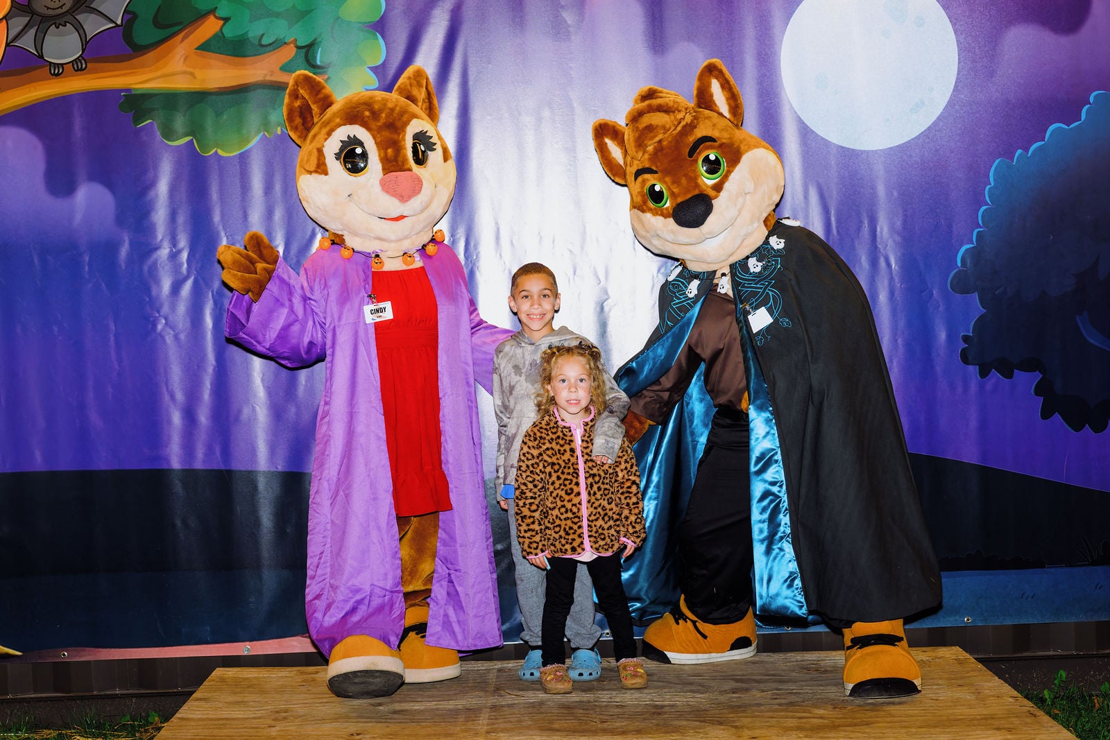 Kids posing with two costumed characters at Enchanted Adventure
